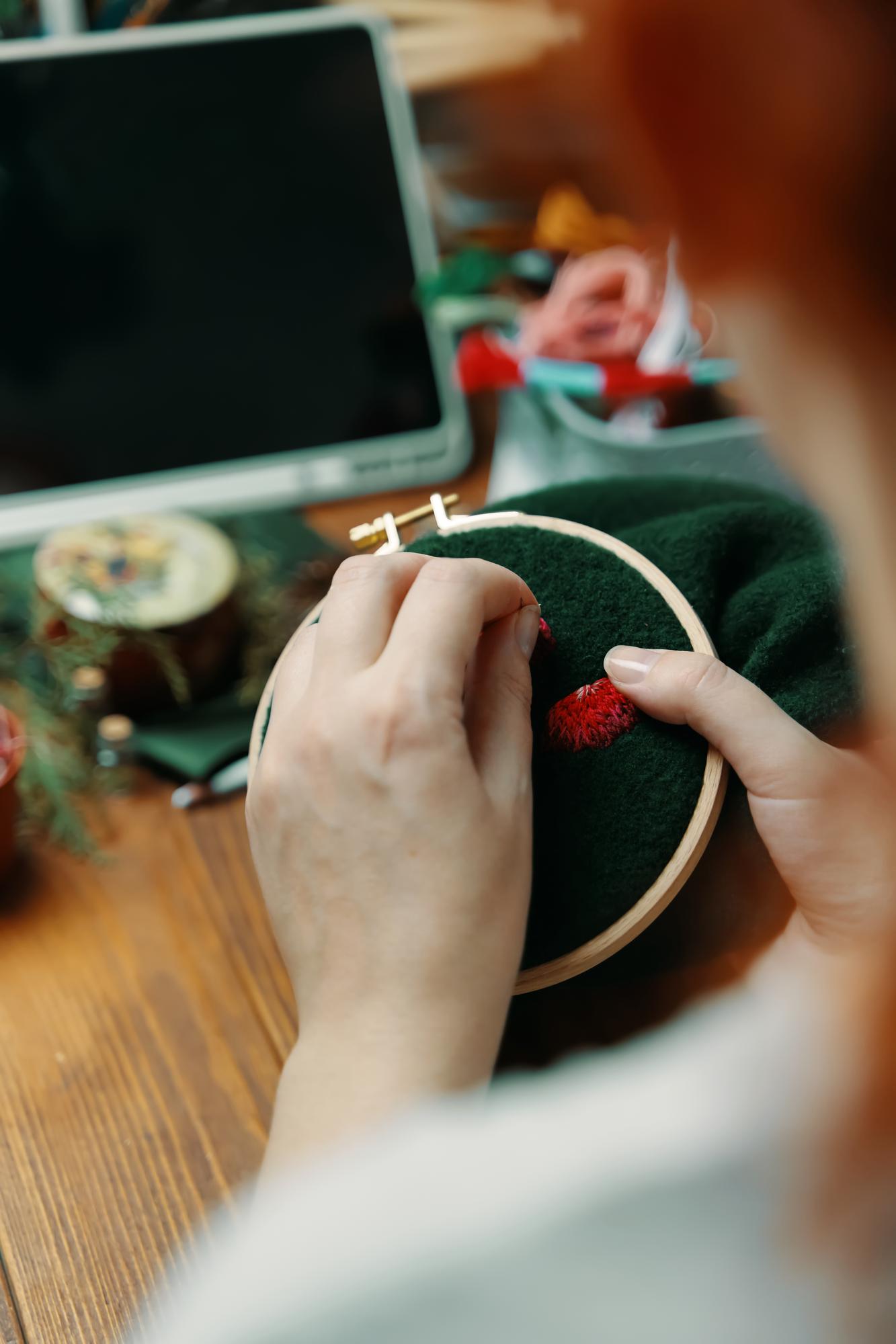 Lead stitcher working with hoop and threads