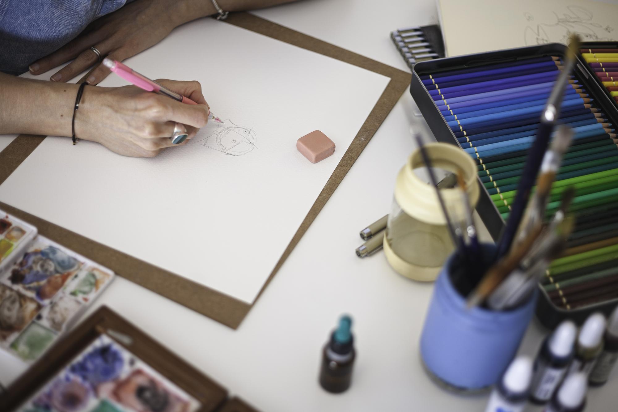 Designer sketching embroidery patterns